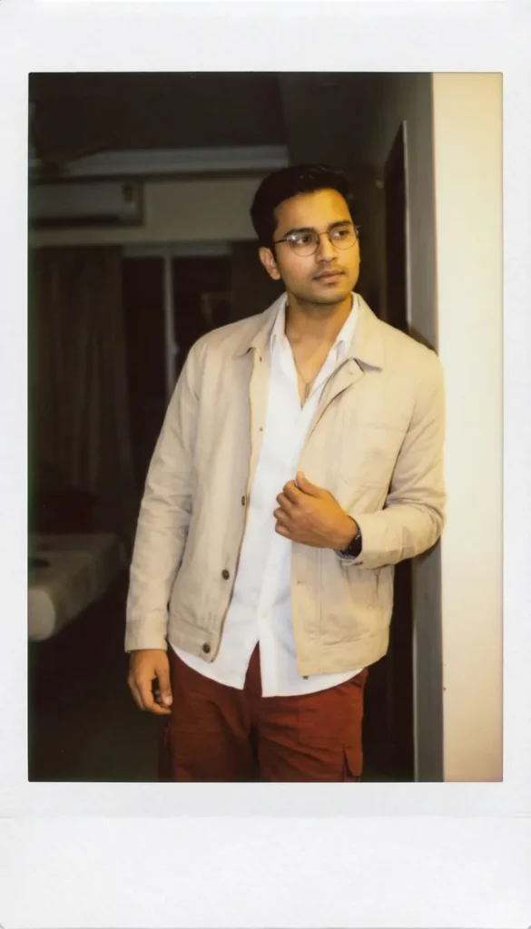 Highly realistic studio-quality polaroid photo of a young man adjusting his jacket, created with an advanced Gemini AI prompt