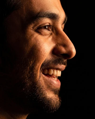 AI-generated image: Chiaroscuro Closeup Portrait: Laughing Man AI Prompt (Gemini)